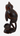 A dark brown carved wooden monkey figurine shown from the back, sitting on a pedestal base against a plain white background.