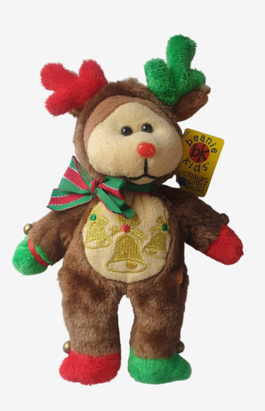 Plush bear toy dressed as a reindeer on a white surface