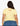 Person wearing a yellow t-shirt with 'Bambi' text on the back, standing against a white background