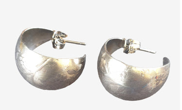 Pair of silver hoop earrings on a white background