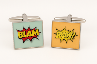 Two square cufflinks with 'BLAM' and 'POW!' designs on a white background