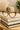 Tortoiseshell cat-eye glasses on a stack of books with a blurred indoor background