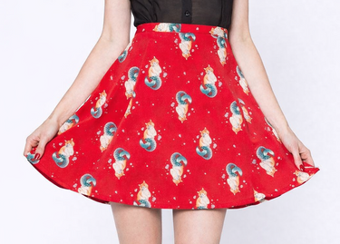 Person wearing a red skirt with cartoon character print on a white background