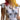 White dress with black cat and flower pattern worn by a person with tattoos and colorful hair.