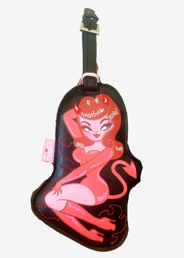 Luggage tag with a stylized design of a woman with devil horns next to a blue vase on a white background
