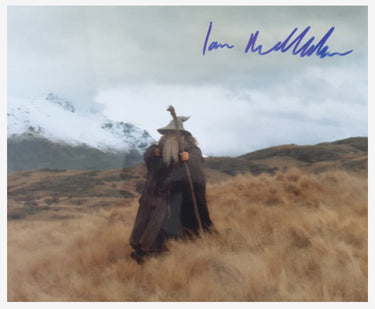 Person on horseback in a scenic landscape with mountains, signed by Ian McKellen.