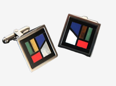A pair of square-shaped cufflinks with a geometric mosaic pattern composed of multiple colors such as blue, green, red, and white on a black background.