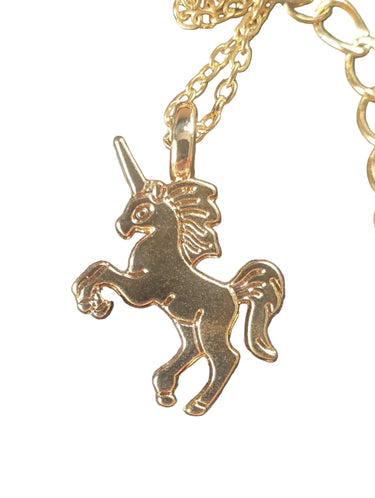 Gold unicorn pendant on a chain against a white background