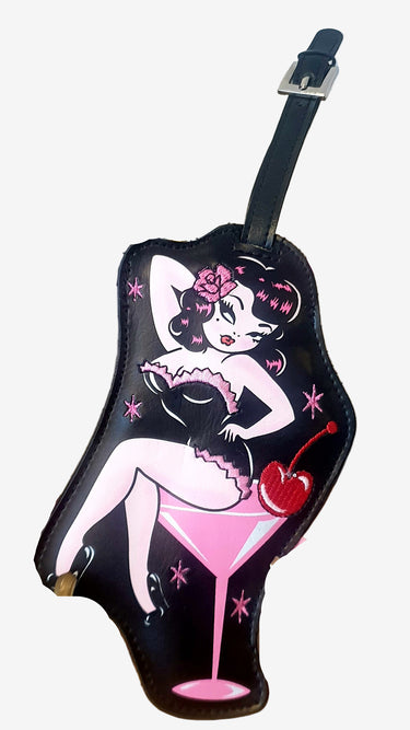 A rectangular black luggage tag with a vintage design featuring a cartoonish character holding a martini glass, and a buckle strap at the top.