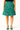 Green skirt with dog pattern worn by a person on a white background
