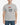 Person wearing a gray t-shirt with a graphic design on a plain background