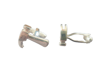 Pair of silver cufflinks on a black background