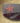 A pair of sunglasses with a Texas star design on the arms, one arm black and the other red.