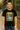 Man wearing a black t-shirt with a graphic design and text, standing in front of a store.