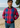 Man wearing a pink and blue checkered jacket on a beach