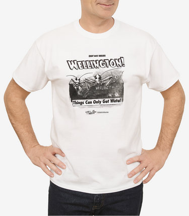 Man wearing a white t-shirt with a graphic design and text on a plain background