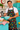 AI lifestyle illustration of a smiling man wearing an apron featuring Atomic Kitchen retro appliance cotton fabric