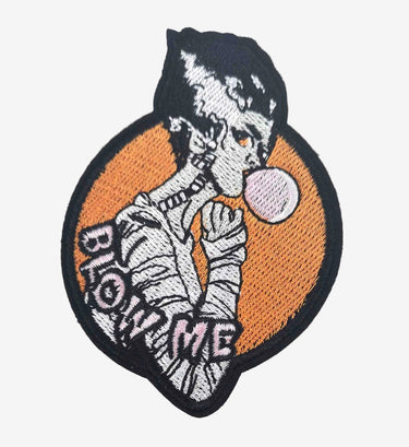Patch with skeleton blowing a pink bubble on an orange background