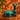 Vintage Blue Mountain Pottery reclining deer in green teal glaze styled against a burnt orange wall with dappled sunlight