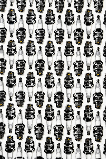 Close-up of black grey and white spark plug pattern on Born to Ride cotton fabric