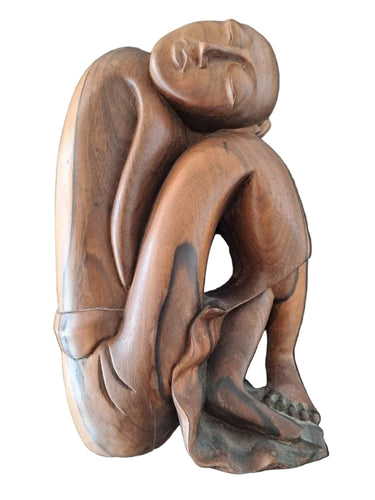 Opposite side of wooden resting man figure showing sculptural back