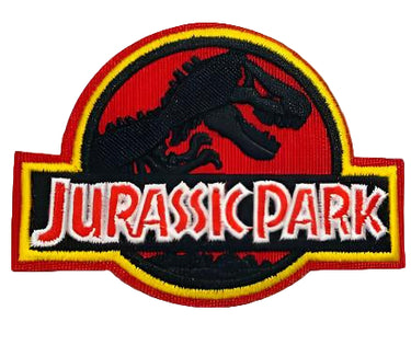 An embroidered patch featuring the Jurassic Park logo with a T-Rex dinosaur skeleton on a red background.