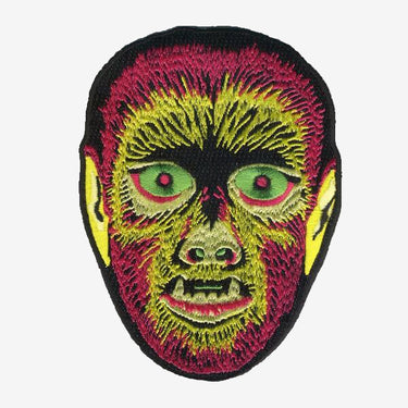 Embroidered patch depicting a werewolf head with vibrant colored threads on a black background.
