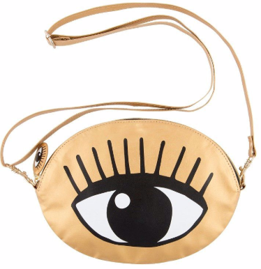 Gold shoulder bag with bold eye graphic, retro glam style crossbody bag worn in lifestyle setting