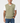 Fairway Outfitters olive green cable knit vest worn over a white t-shirt