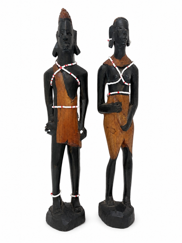Pair of hand-carved African style wooden male and female figure sculptures with bead detail