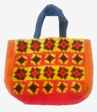 Colourful handmade crochet granny square tote bag with orange, yellow and black retro patterning.