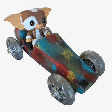 Handpainted wooden racing car sculpture with colourful abstract finish and translucent skate wheels