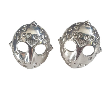 Silver cufflinks with intricate designs on a white background
