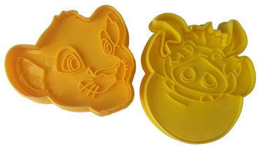 Two yellow cookie cutters shaped like cartoon characters on a white background