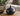 Matte black sculptural ceramic vase with rounded body and narrow neck.