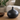 Matte black sculptural ceramic vase with rounded body and narrow neck.