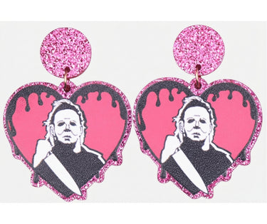 Pair of pink glitter Michael Myers Halloween heart-shaped acrylic stud drop earrings on a light background
