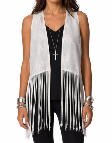 Off white fringe vest by Atmos & Here layered over a black top, showing embroidered detail and long fringe movement