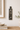 Decorative wall art with a face and abstract shapes on a neutral wall.