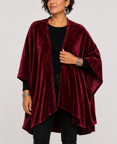 Woman wearing a berry velvet Planet Retro throw cape with dramatic draped silhouette and crushed velvet texture.