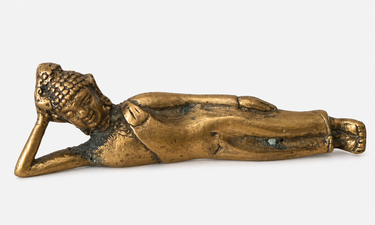 small reclining Buddha metal figurine with aged patina decorative accent