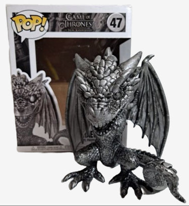 A metallic black Funko Pop vinyl figure of Rhaegal, a dragon from Game of Thrones, sitting with its wings extended, packaging in the background.