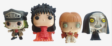 Four Funko Pop! figures on a white surface with a wooden base.