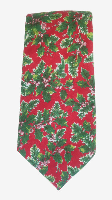 Red tie with green holly leaf pattern on a white background