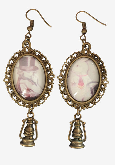 Pair of earrings with vintage-style design on a dark background