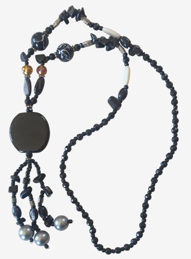 Black beaded necklace on a light background