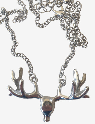 Silver deer pendant on a chain against a white background