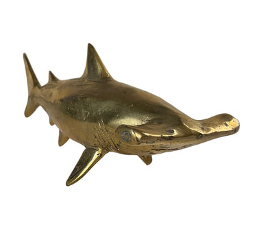 Solid brass hammerhead shark sculpture with sleek curved body and polished golden finish.
