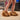 Person wearing fluffy Star Wars Chewbacca slippers on a wooden floor