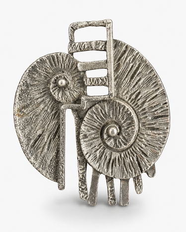 A textured silver-toned metal hair claw clip with a sculptural, organic design resembling two overlapping spiral forms and a small rectangular loop at the top, shown on a light gray background.